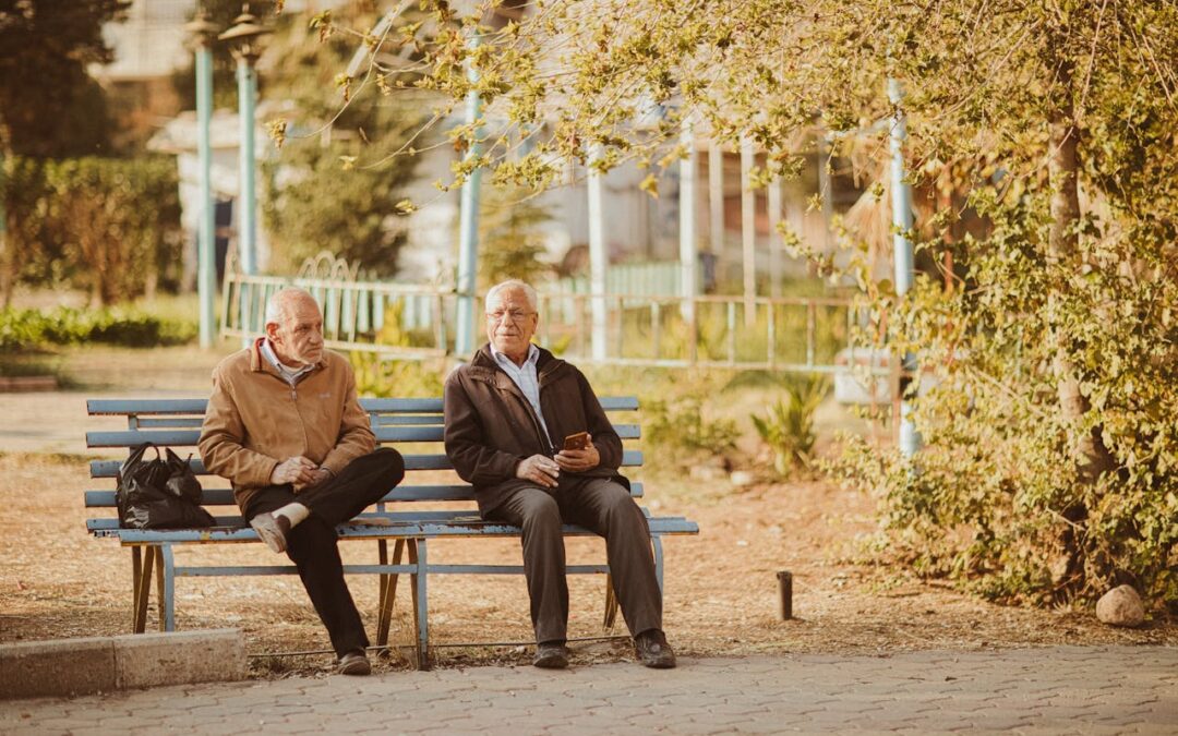 Two friends sitting on a park bench
